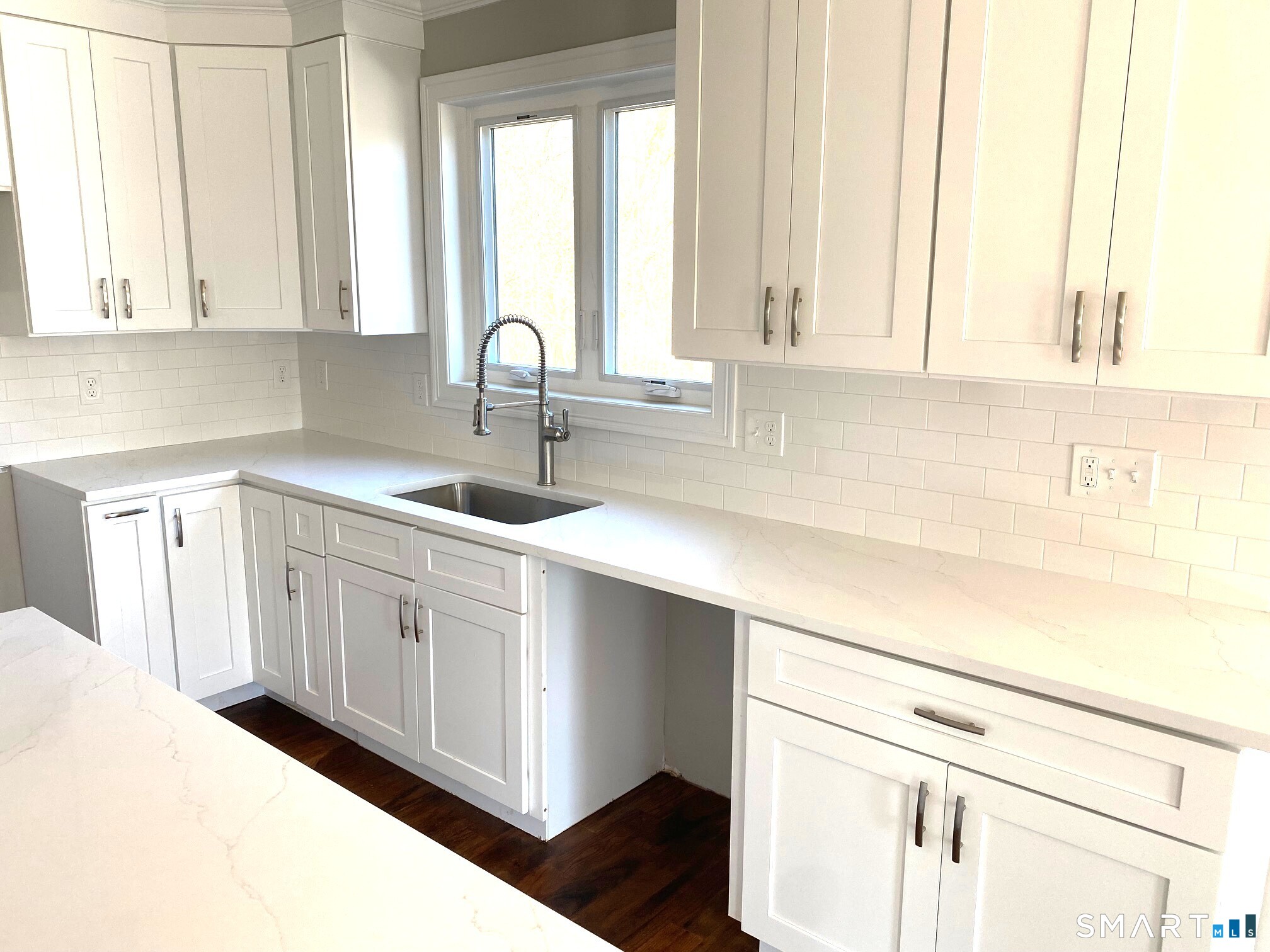 277 Alba Avenue Bridgeport, CT 06606 - Photo 11 of 37 a kitchen with white cabinets and sink