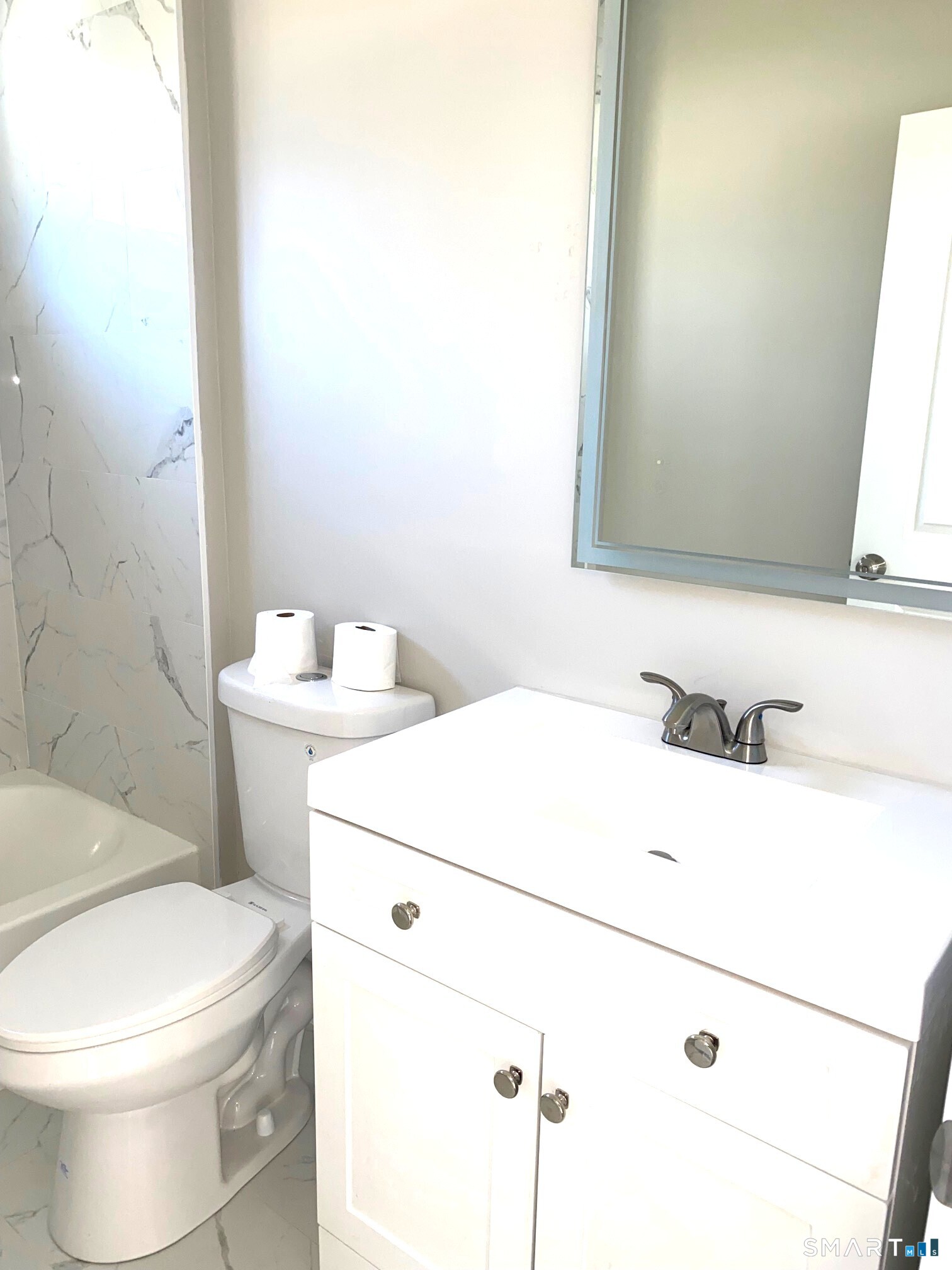 277 Alba Avenue Bridgeport, CT 06606 - Photo 18 of 37 a bathroom with a sink a toilet and a mirror