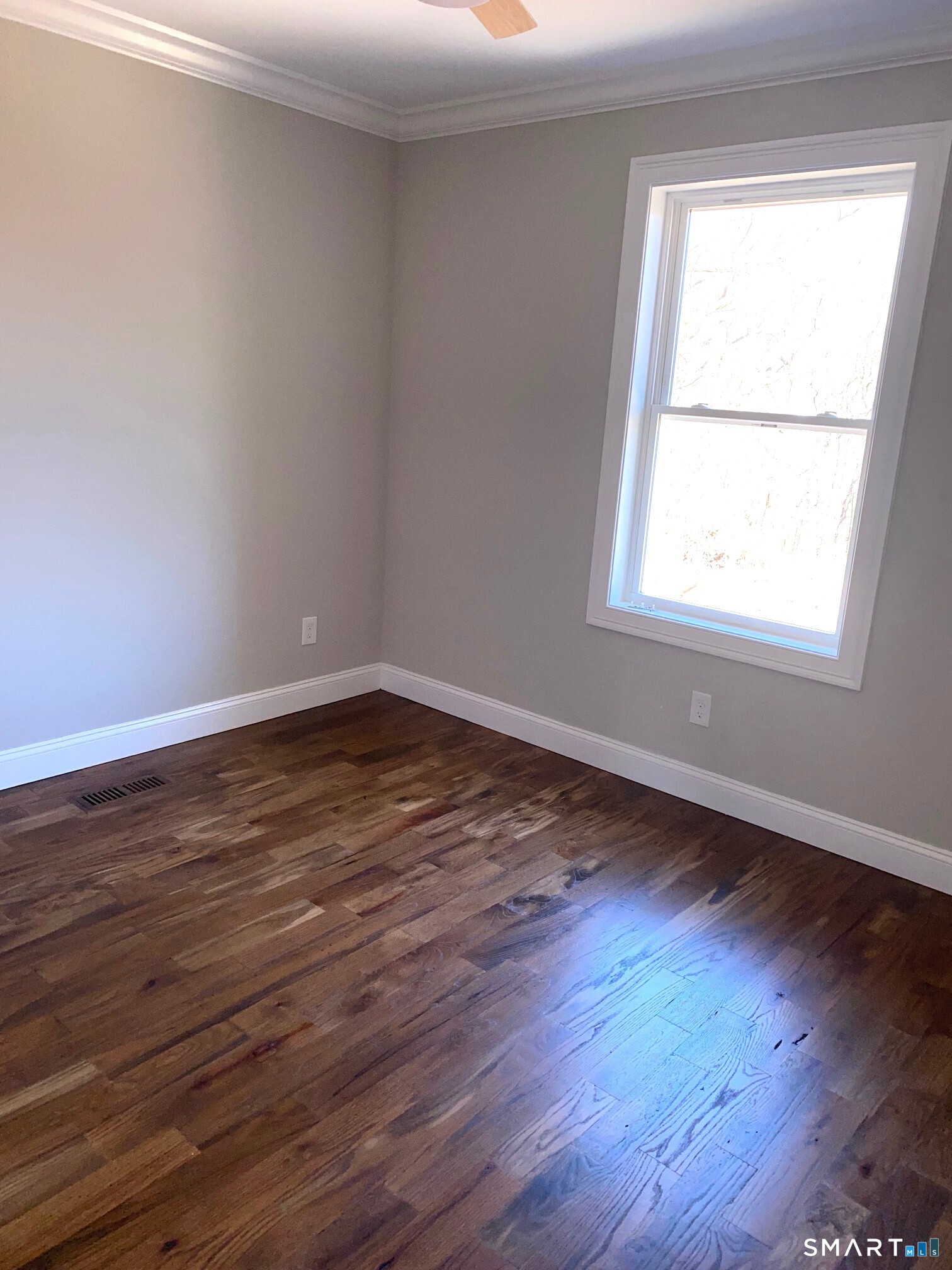 277 Alba Avenue Bridgeport, CT 06606 - Photo 25 of 37 an empty room with wooden floor and windows