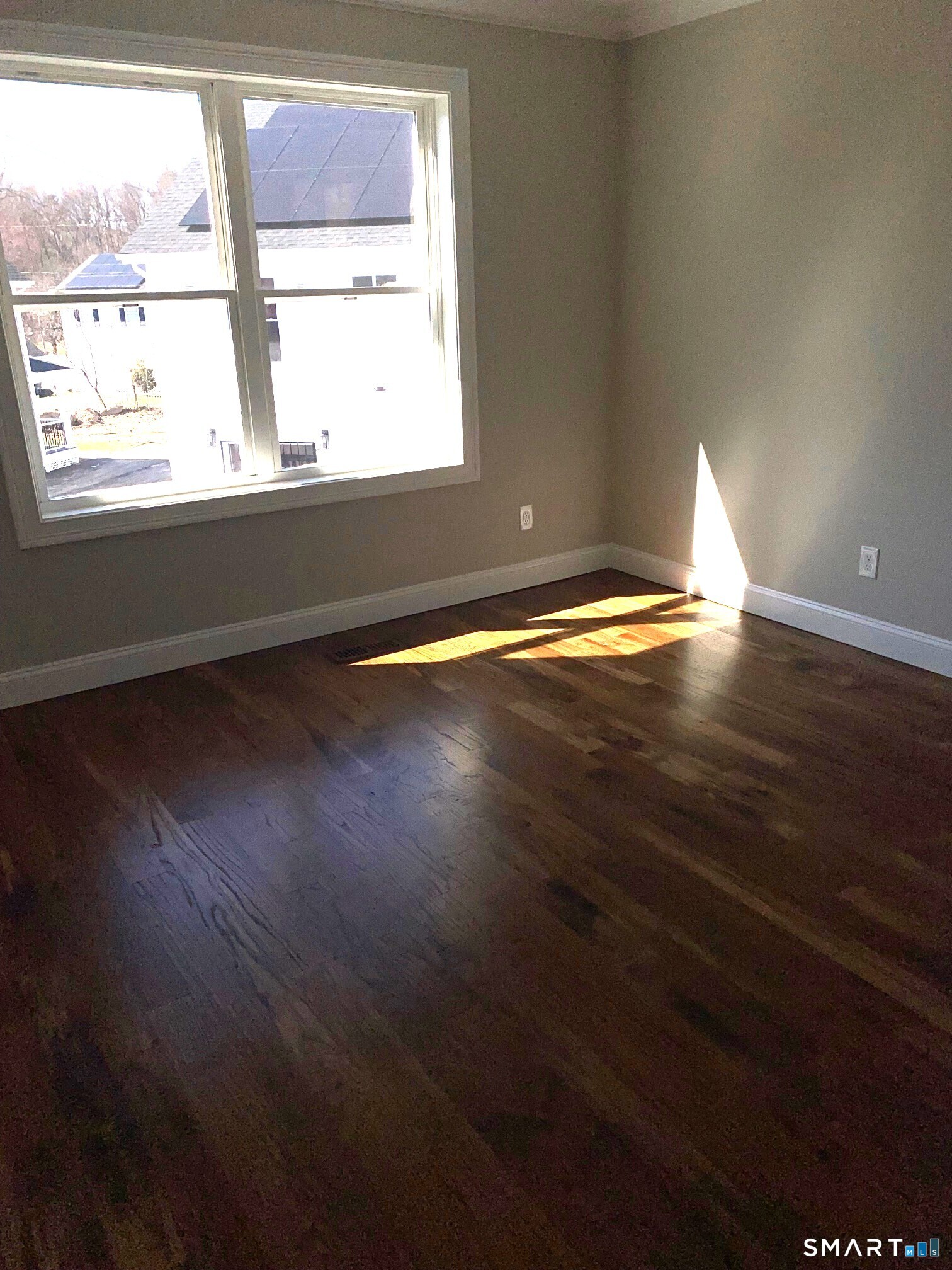 277 Alba Avenue Bridgeport, CT 06606 - Photo 26 of 37 an empty room with wooden floor and windows