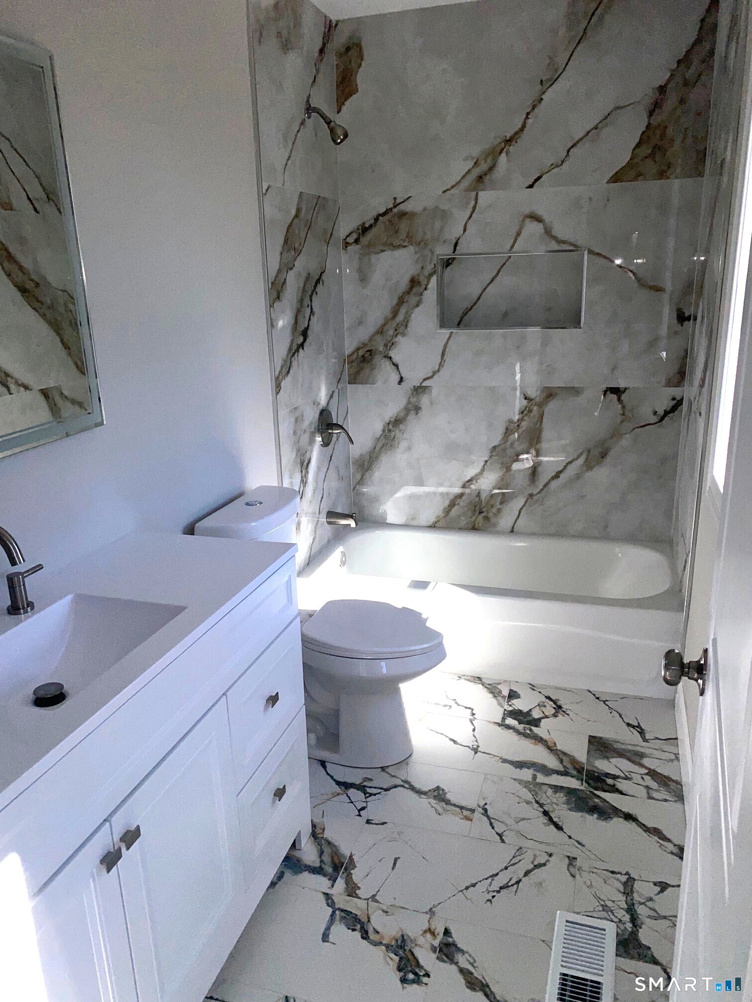 277 Alba Avenue Bridgeport, CT 06606 - Photo 31 of 37 a bathroom with a sink mirror vanity and toilet