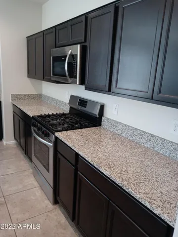 a kitchen with granite countertop cabinets and steel stainless steel appliances