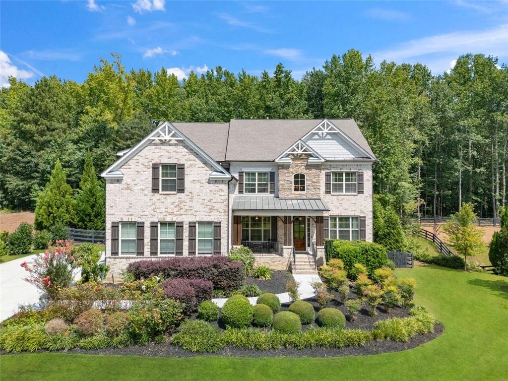 a aerial view of a house with yard and green space