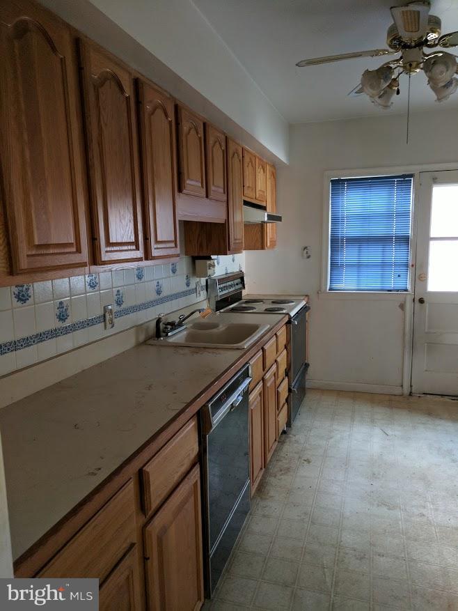 3305 Marnat Road Baltimore, MD 21208 - Photo 4 of 7 a kitchen with stainless steel appliances granite countertop a sink stove and cabinets