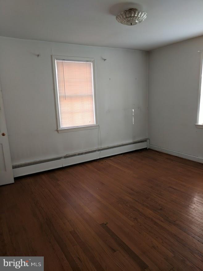 3305 Marnat Road Baltimore, MD 21208 - Photo 5 of 7 an empty room with wooden floor and windows