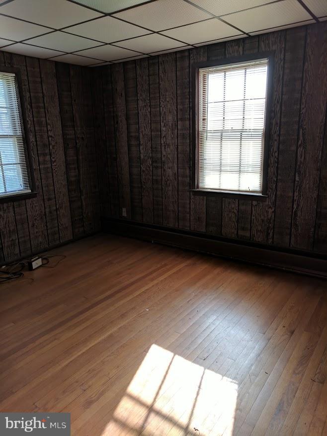 3305 Marnat Road Baltimore, MD 21208 - Photo 6 of 7 a view of an empty room with wooden floor and a window