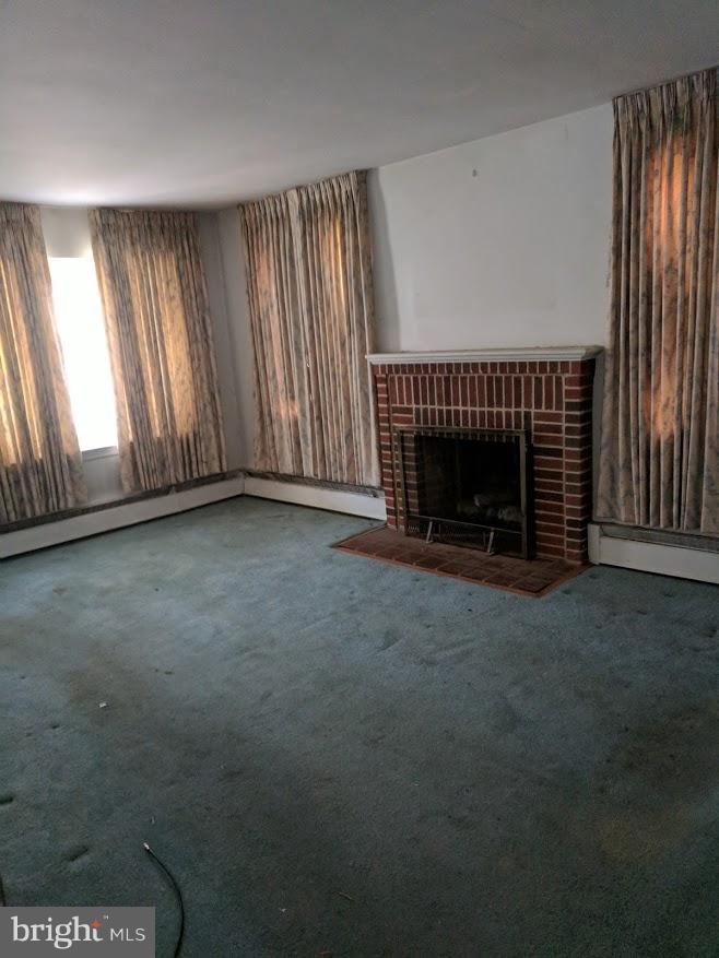 3305 Marnat Road Baltimore, MD 21208 - Photo 7 of 7 an empty room with floor to ceiling window and fireplace