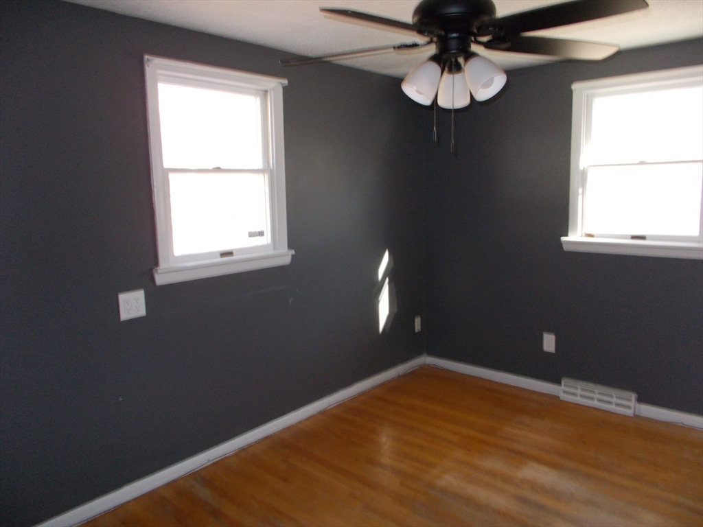 146 South Meadow Road Carver, MA 02330 - Photo 11 of 15 a view of an empty room with wooden floor and a window