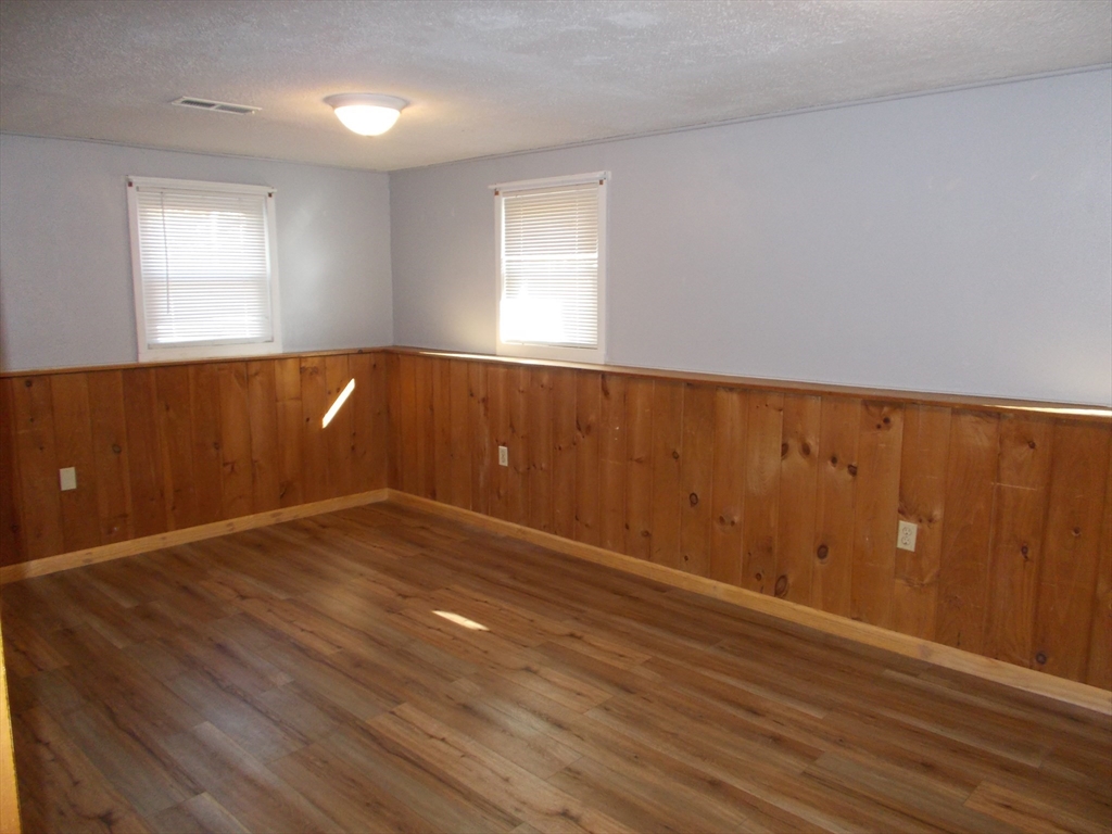 146 South Meadow Road Carver, MA 02330 - Photo 13 of 15 an empty room with wooden floor and windows