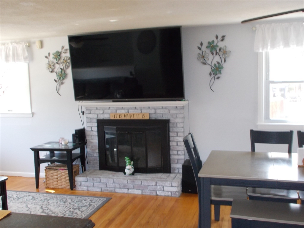 146 South Meadow Road Carver, MA 02330 - Photo 3 of 15 a living room with furniture and a fireplace