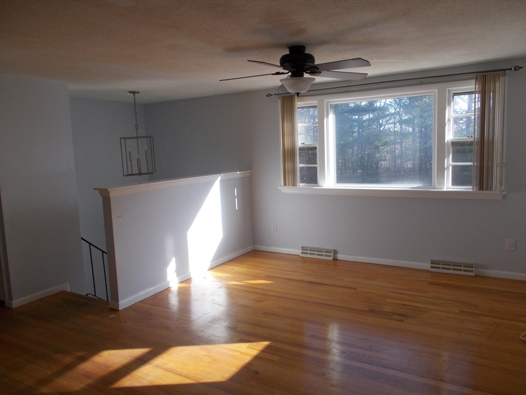 146 South Meadow Road Carver, MA 02330 - Photo 6 of 15 a view of an empty room with wooden floor and a window