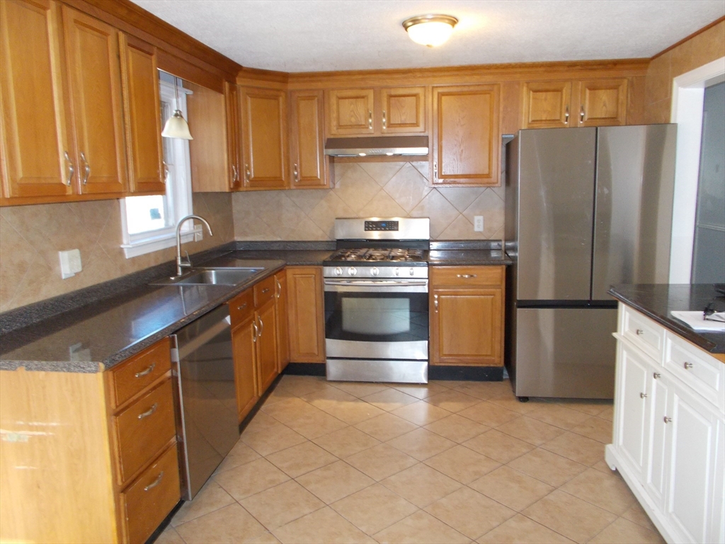 146 South Meadow Road Carver, MA 02330 - Photo 7 of 15 a kitchen with stainless steel appliances granite countertop a stove a refrigerator and a sink