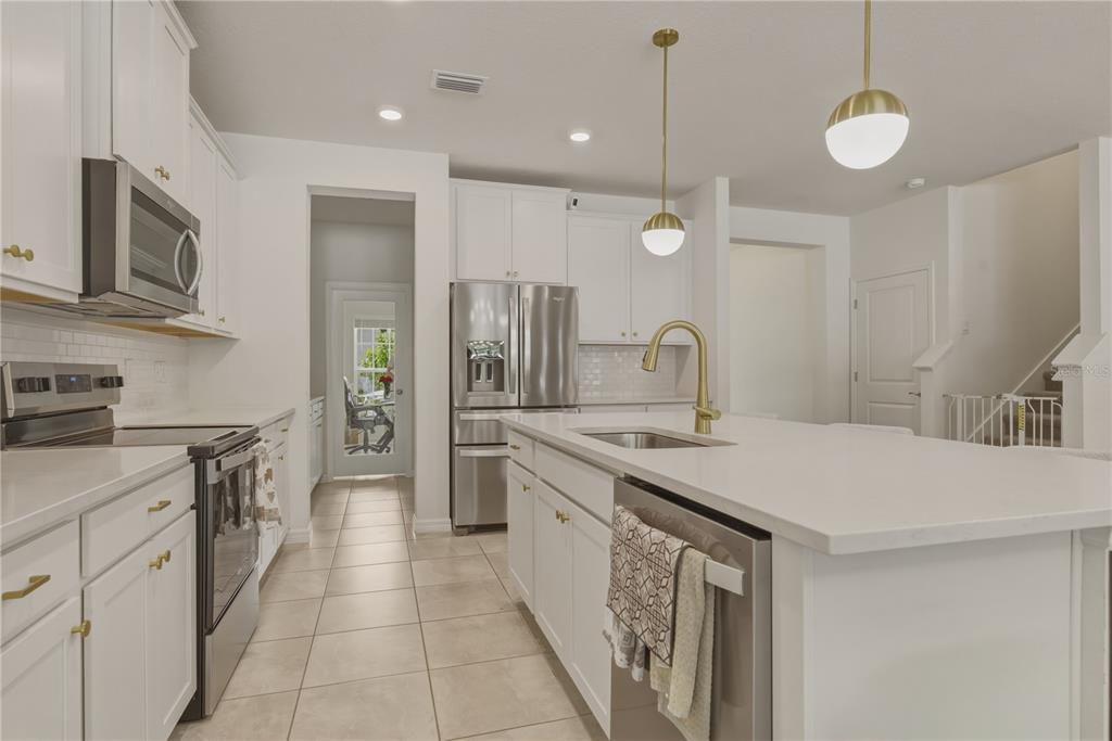17664 Northwest 173rd Road Alachua, FL 32615 - Photo 12 of 31 a kitchen with a sink a stove oven and refrigerator