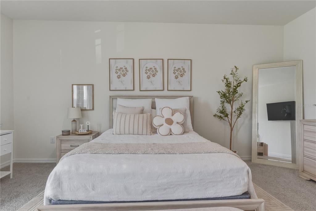 17664 Northwest 173rd Road Alachua, FL 32615 - Photo 15 of 31 a bedroom with a bed and a potted plant