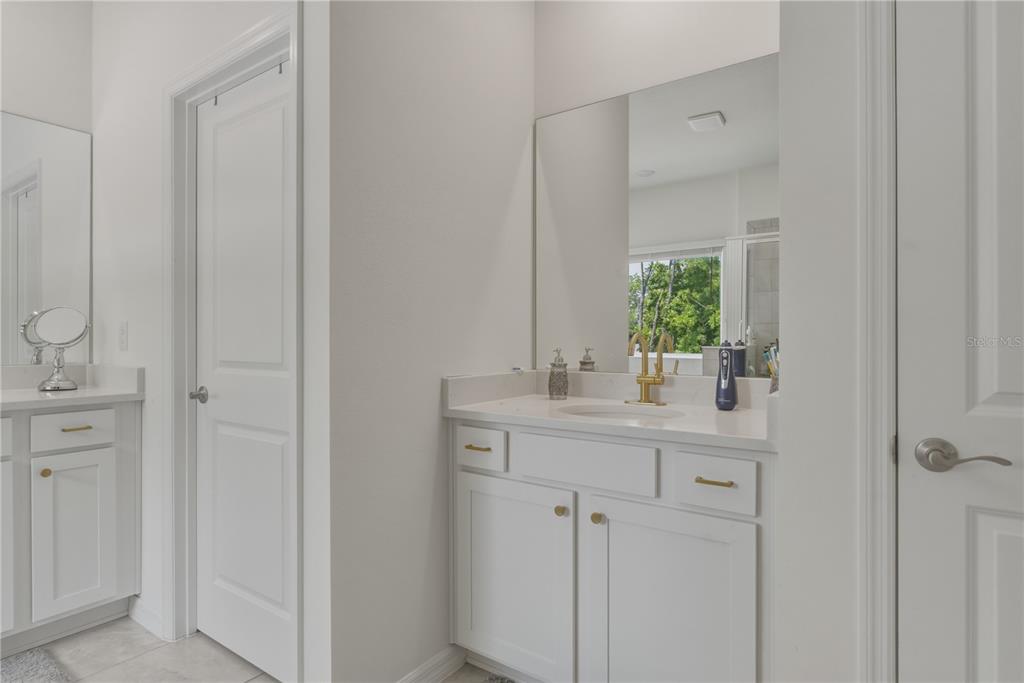 17664 Northwest 173rd Road Alachua, FL 32615 - Photo 19 of 31 a bathroom with a granite countertop sink and a mirror