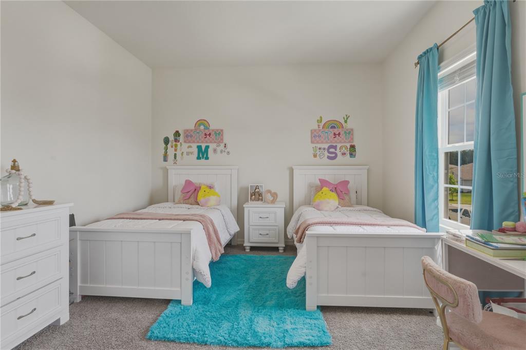 17664 Northwest 173rd Road Alachua, FL 32615 - Photo 24 of 31 a bedroom with two beds and a window
