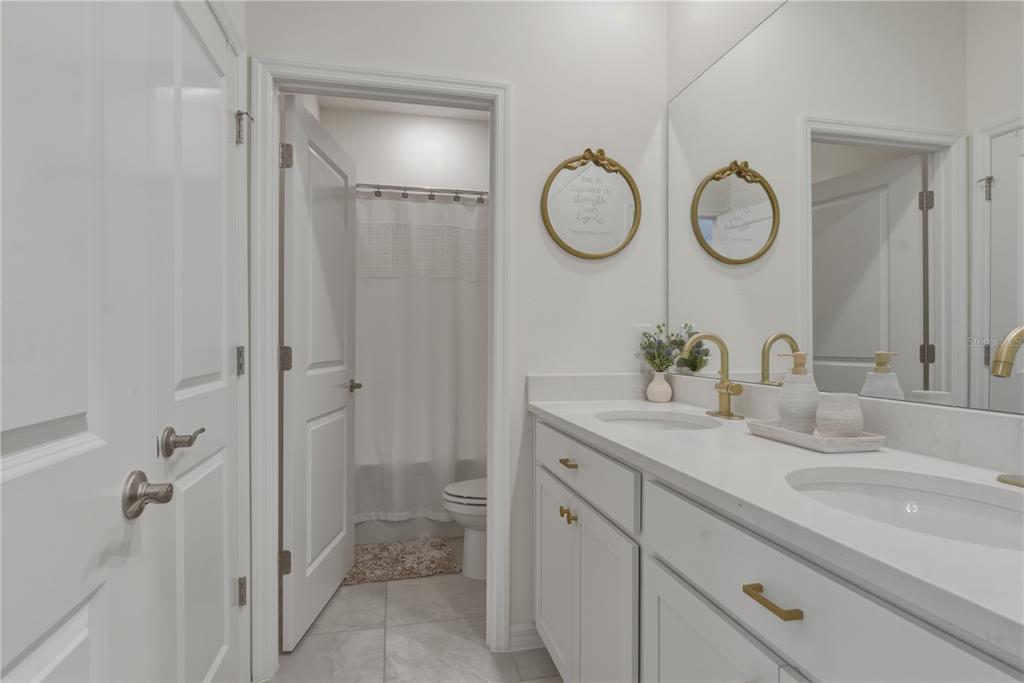 17664 Northwest 173rd Road Alachua, FL 32615 - Photo 25 of 31 a bathroom with a double vanity sink mirror and shower