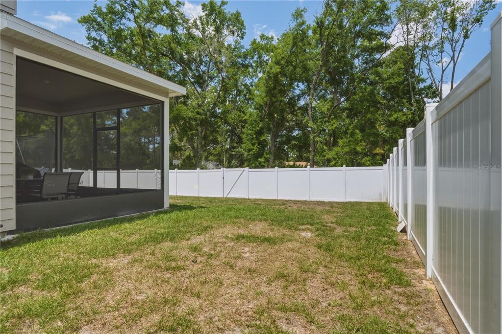 17664 Northwest 173rd Road Alachua, FL 32615 - Photo 28 of 31 a view of backyard with garden and tall tree