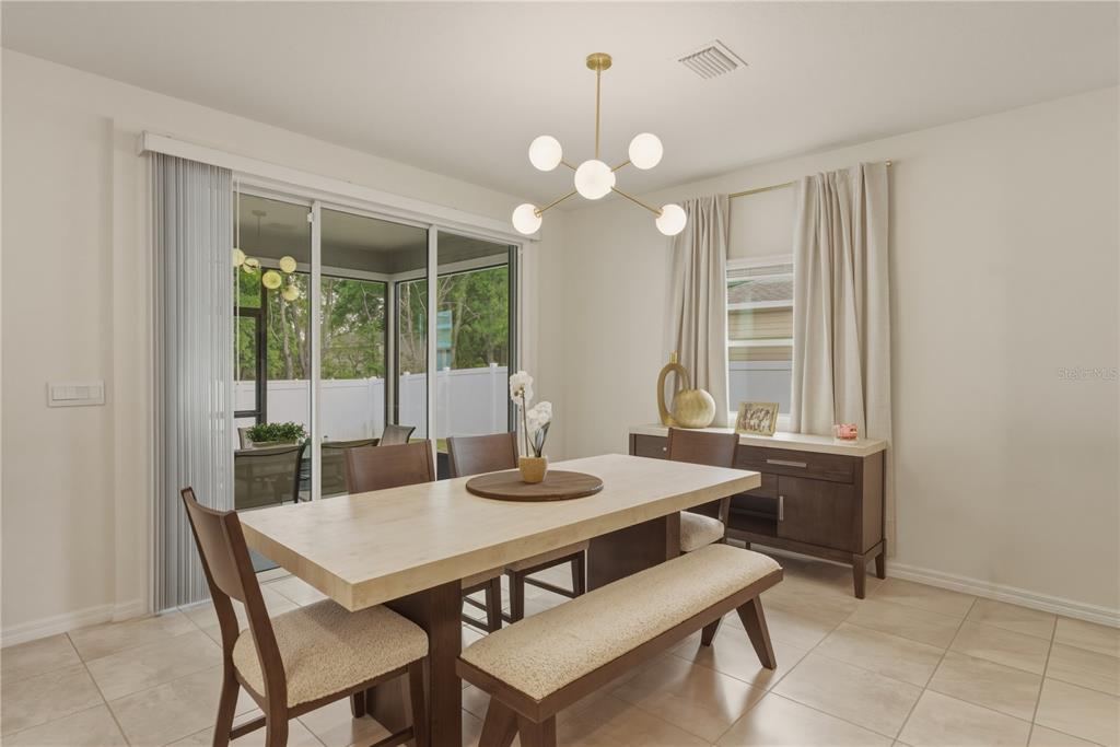17664 Northwest 173rd Road Alachua, FL 32615 - Photo 6 of 31 a view of a dining room with furniture and window