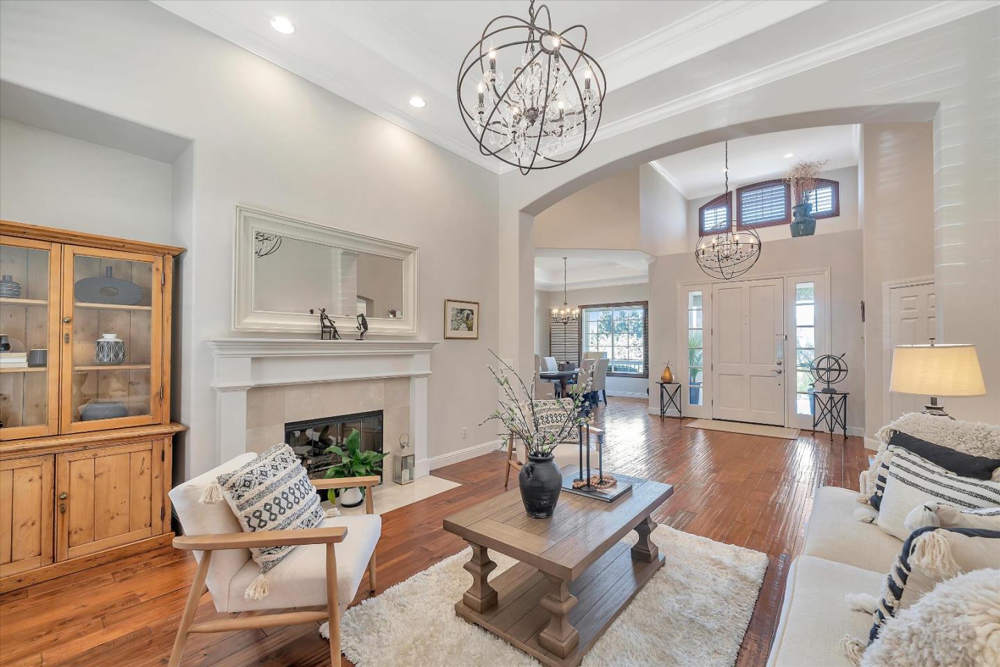 2380 Sunflower Circle Gilroy, CA 95020 - Photo 8 of 43 a living room with furniture a chandelier and a fireplace