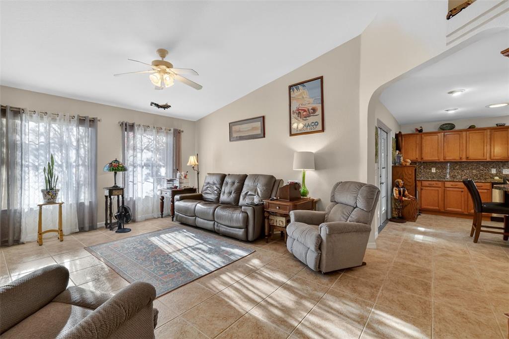 12193 Southeast 175th Loop Summerfield, FL 34491 - Photo 11 of 34 a living room with furniture and a chandelier