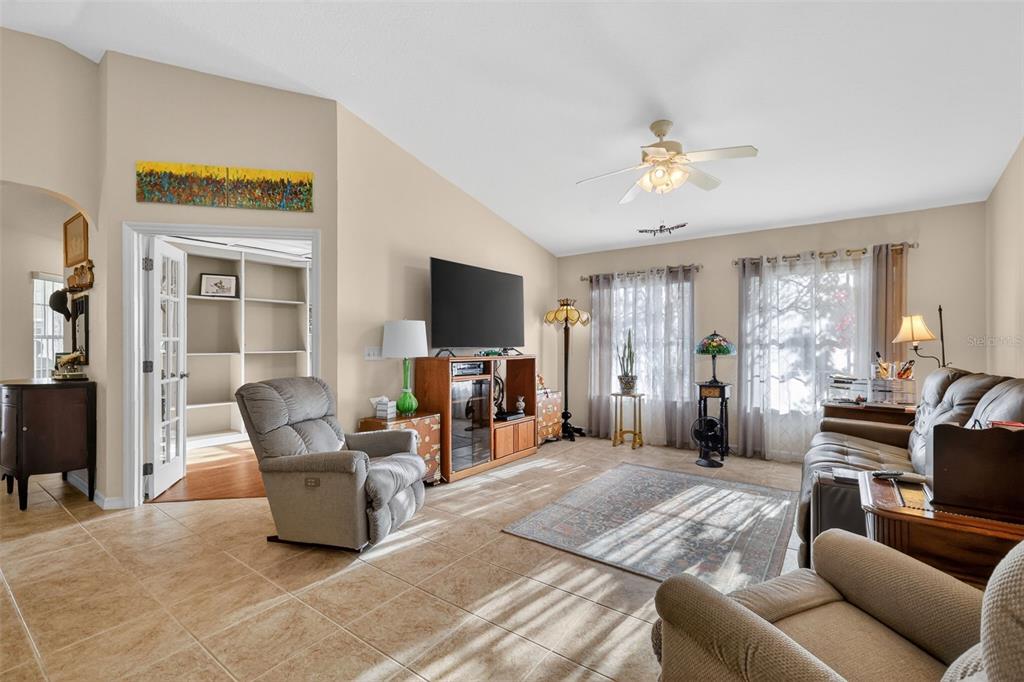 12193 Southeast 175th Loop Summerfield, FL 34491 - Photo 14 of 34 a living room with furniture a ceiling fan and a flat screen tv