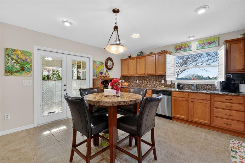 12193 Southeast 175th Loop Summerfield, FL 34491 - Photo 16 of 34 a view of a kitchen with a dining table and chairs