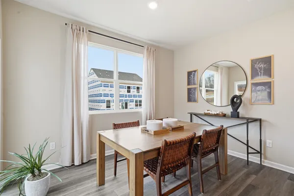 a dining room with furniture and wooden floor