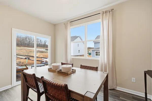 a view of a dining room with furniture window and wooden floor