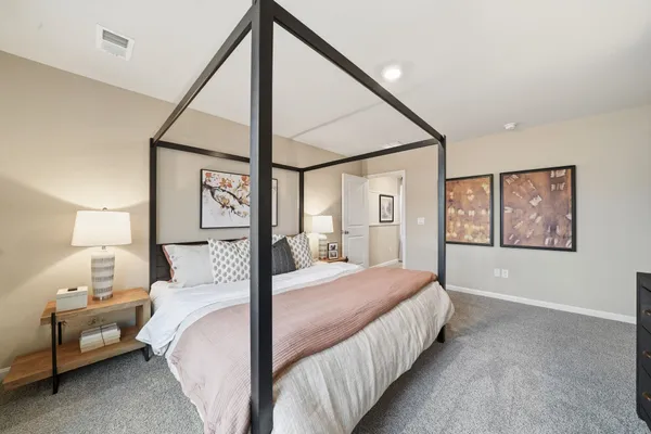 a bedroom with a bed a mirror and a window