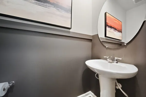 a bathroom with a sink a mirror and a toilet