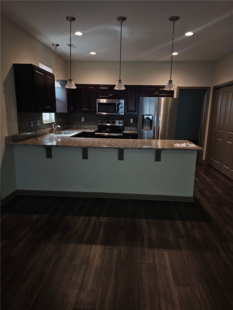 235 Pendleton Road Clemson, SC 29631 - Photo 7 of 21 This modern kitchen features rich cabinetry, sleek appliances, and a convenient breakfast bar.