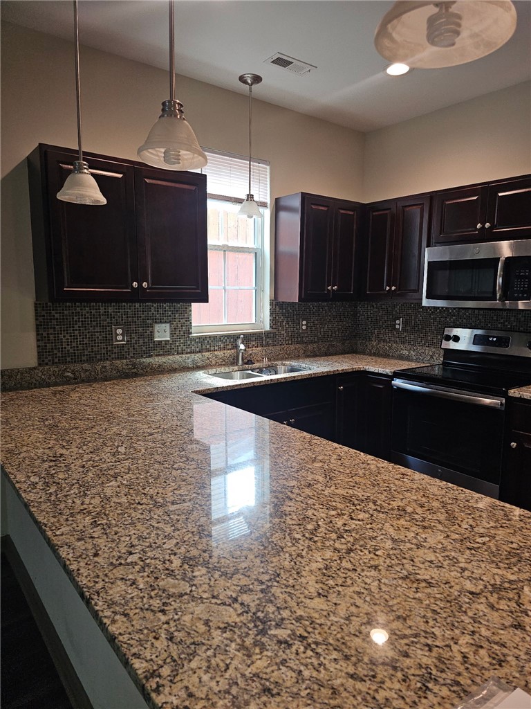 235 Pendleton Road Clemson, SC 29631 - Photo 9 of 21 This modern kitchen features rich cabinetry, lustrous granite, and ample space for culinary creations.