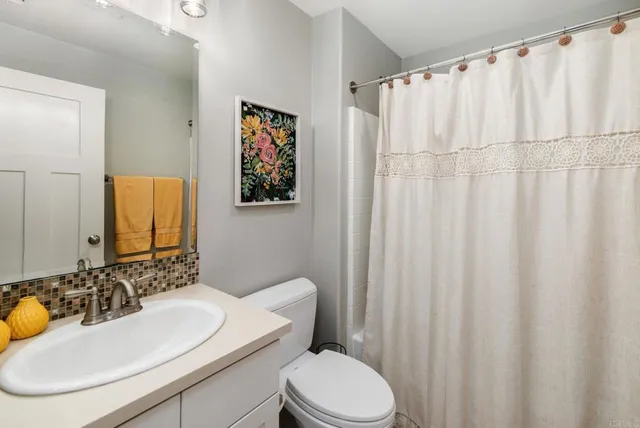 a bathroom with a toilet sink and a mirror