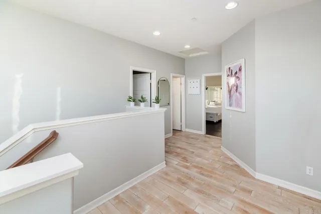 a view of hallway with wooden floor