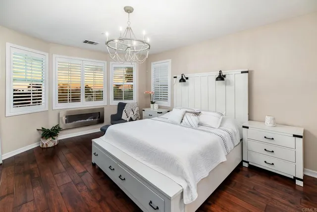 a bed room with a bed and a chandelier