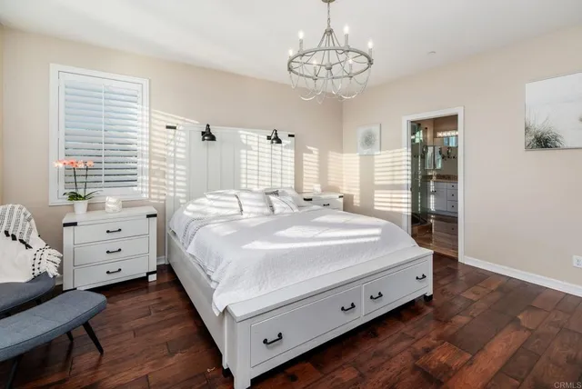 a spacious bedroom with a bed and a dresser