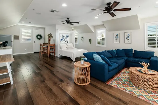 a living room with furniture and wooden floor