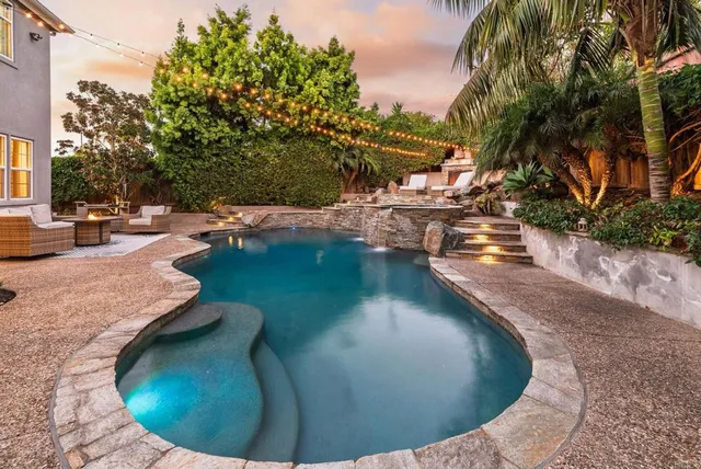 a view of a swimming pool with sitting area