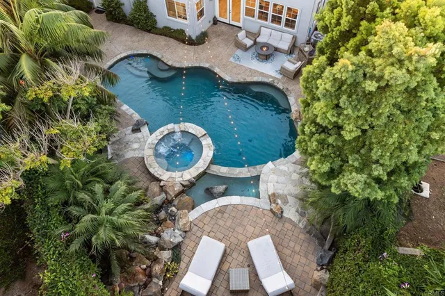 an aerial view of a house with garden space and sitting area