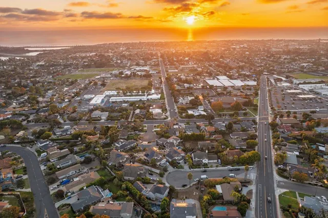 an aerial view of residential building with green space