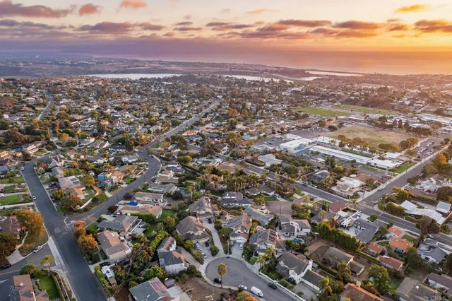 an aerial view of residential houses with city view