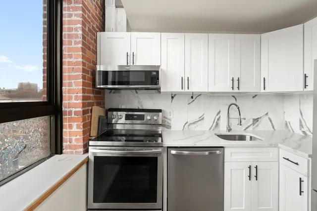 a kitchen with stainless steel appliances granite countertop a refrigerator and a sink