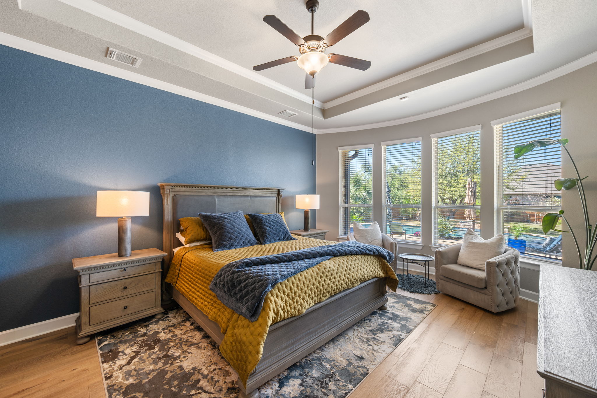 4118 Capora Way Round Rock, TX 78681 - Photo 14 of 39 a bedroom with a bed couches and a large window with wooden floor