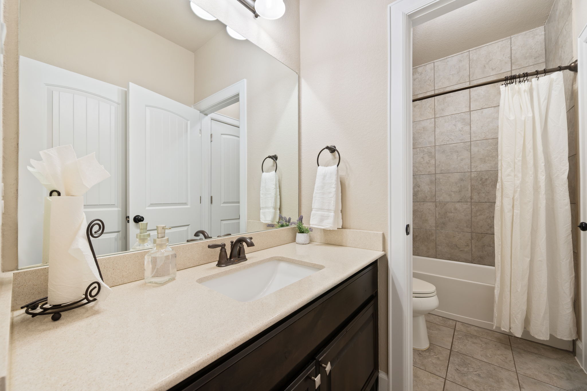 4118 Capora Way Round Rock, TX 78681 - Photo 27 of 39 a bathroom with a double vanity sink a mirror and a bathtub