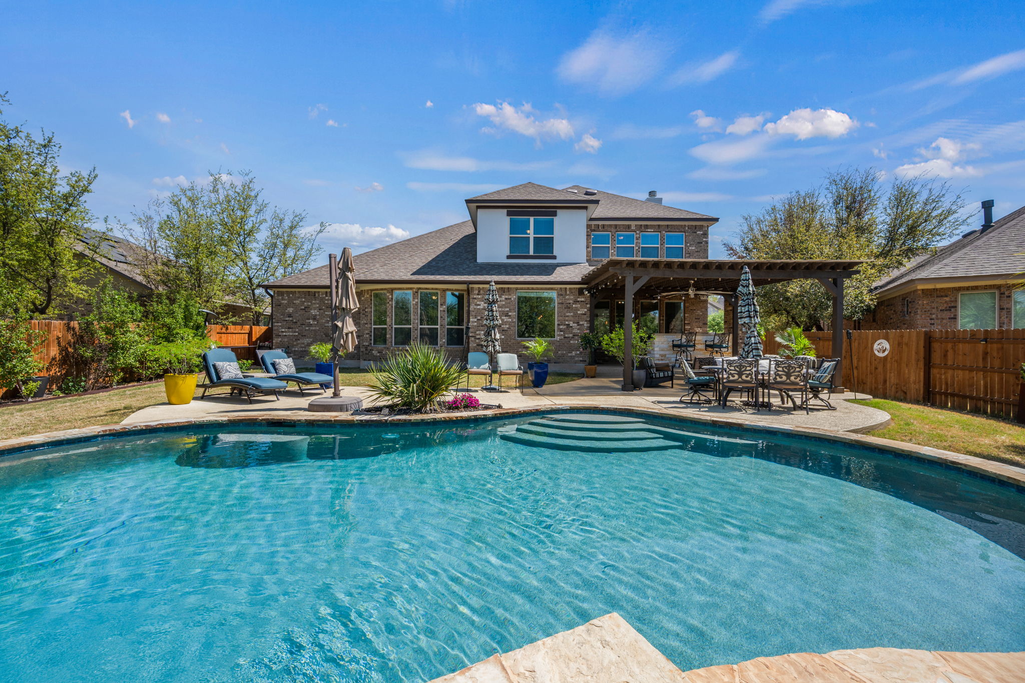 4118 Capora Way Round Rock, TX 78681 - Photo 34 of 39 a view of swimming pool with lawn chairs and a yard