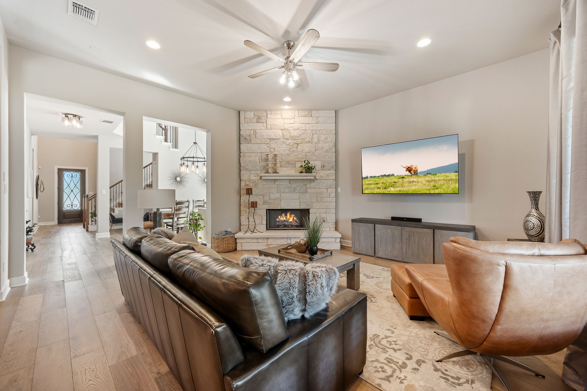 4118 Capora Way Round Rock, TX 78681 - Photo 7 of 39 a living room with furniture a fireplace and a flat screen tv