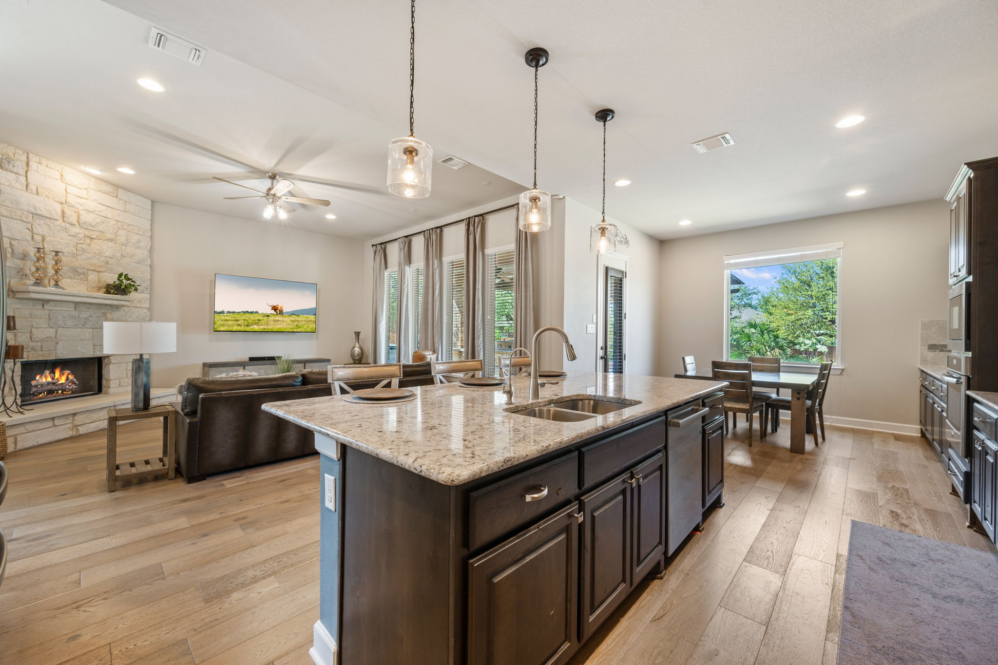 4118 Capora Way Round Rock, TX 78681 - Photo 10 of 39 a kitchen with stainless steel appliances granite countertop sink stove and wooden floor