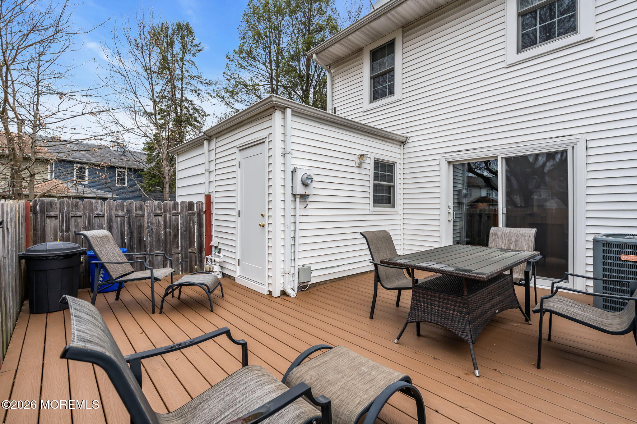 72 Kingsley Way Freehold, NJ 07728 - Photo 29 of 36 a view of a roof deck with table and chairs with wooden floor and fence