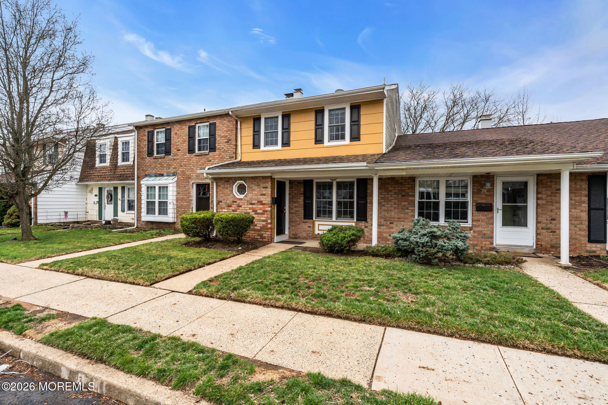 72 Kingsley Way Freehold, NJ 07728 - Photo 33 of 36 front view of a brick house with a yard